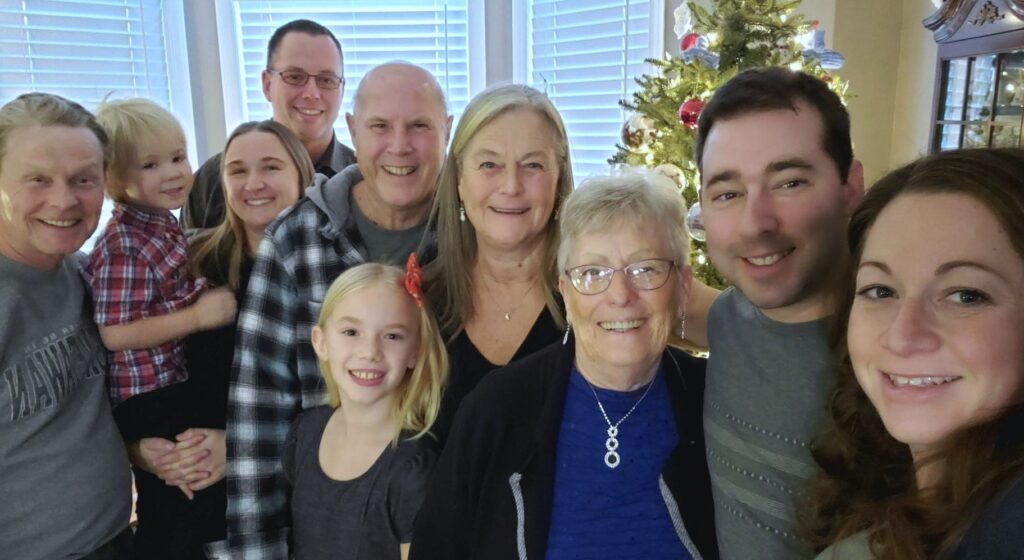 The ware family in front of a Christmas tree